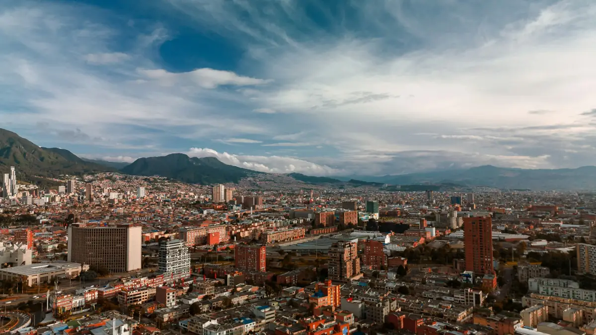 Bogota spread across the high plateau beneath the Andes under a cloudy sky.