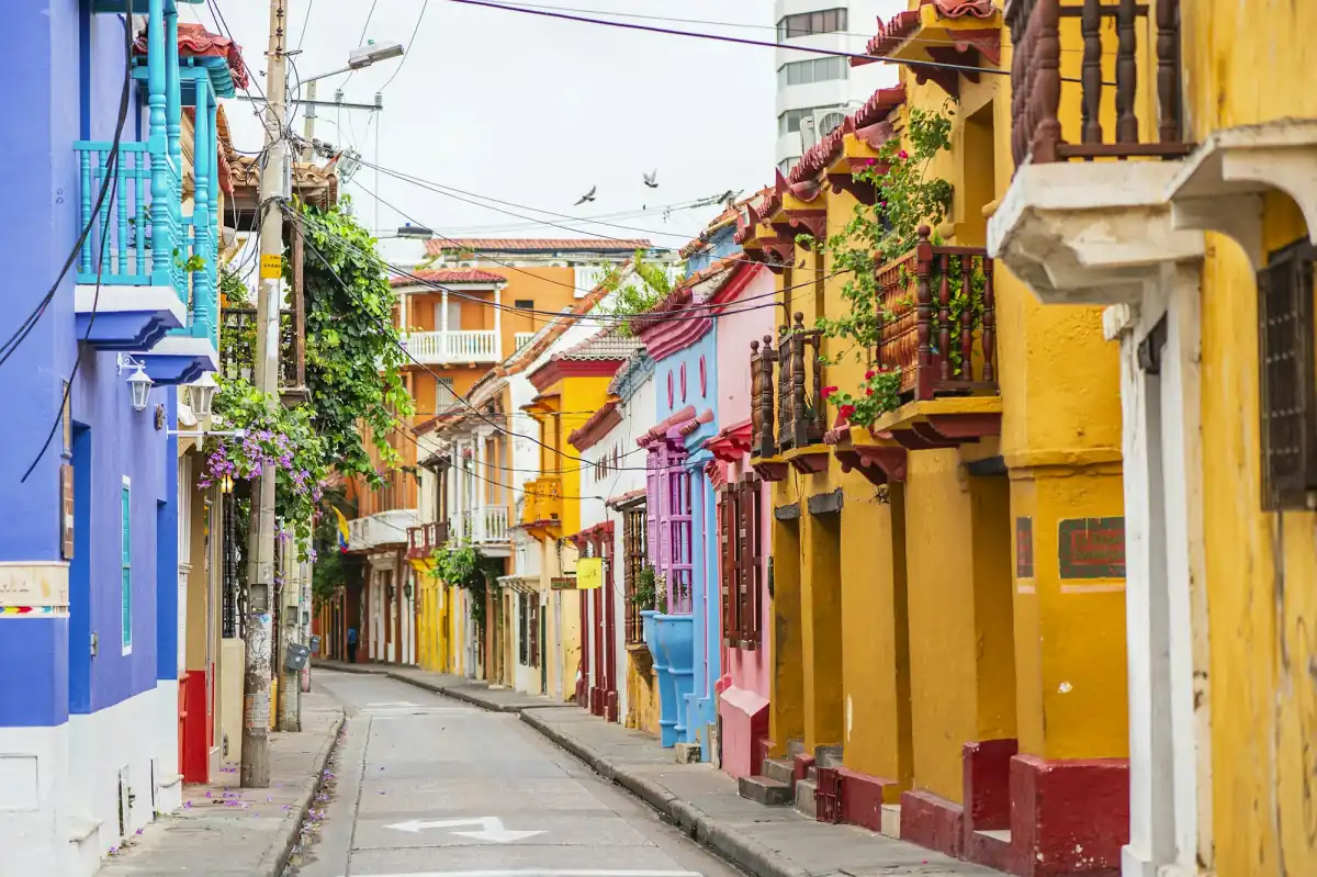 A street of brightly painted colonial houses with balconies in Cartagena's old town.