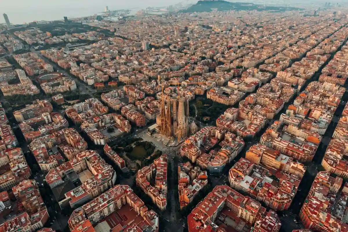 An aerial view of Barcelona's grid of Eixample blocks around the Sagrada Familia.