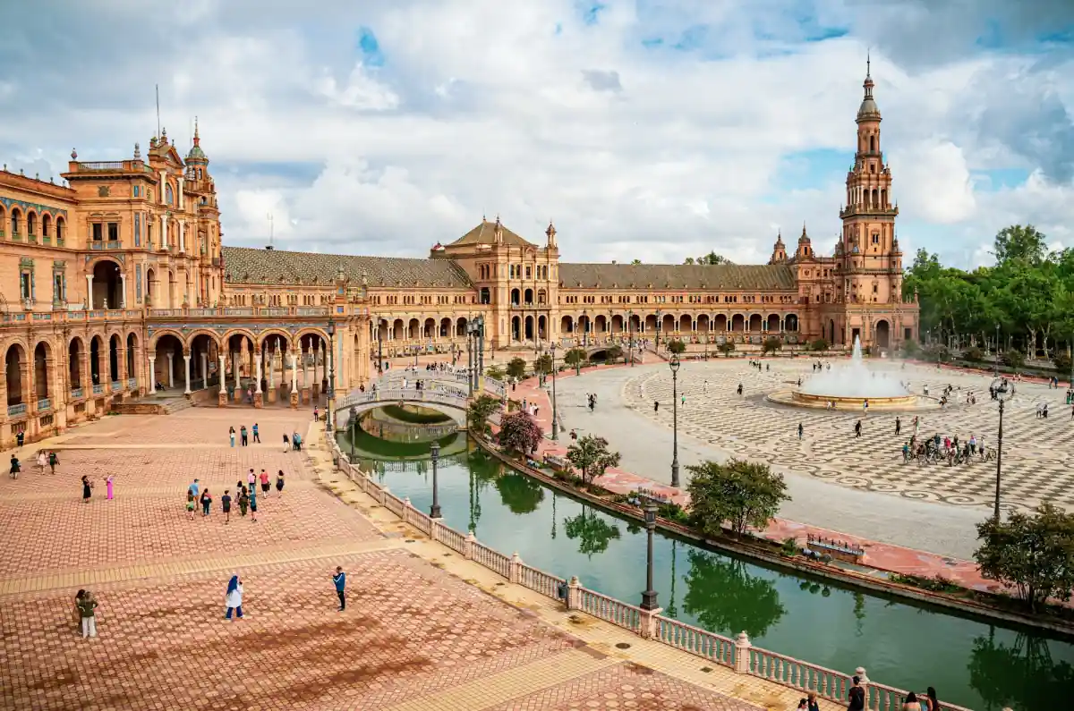 The Plaza de Espana in Seville, with its curved brick building, tower and canal.